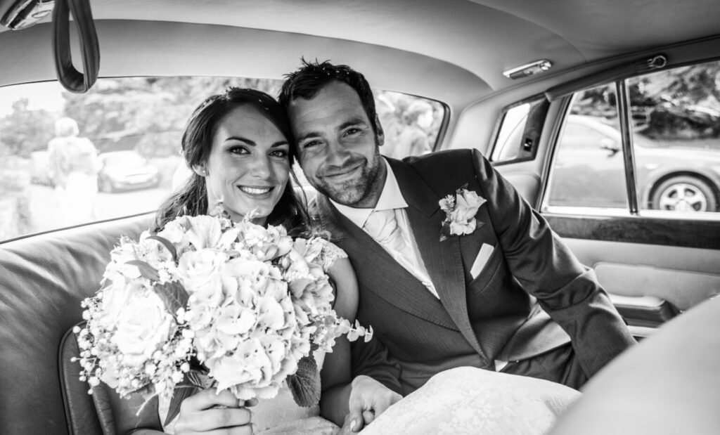 Georgina & Alexander on the first wedding at Lakeside Country barn sat in their wedding car. 