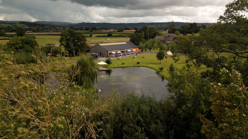 Somerset wedding photography aerial view of waterside country barn
