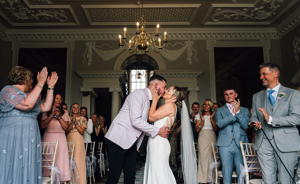 Bride and groom share a first kiss at crowcombe court Wedding Photography Somerset