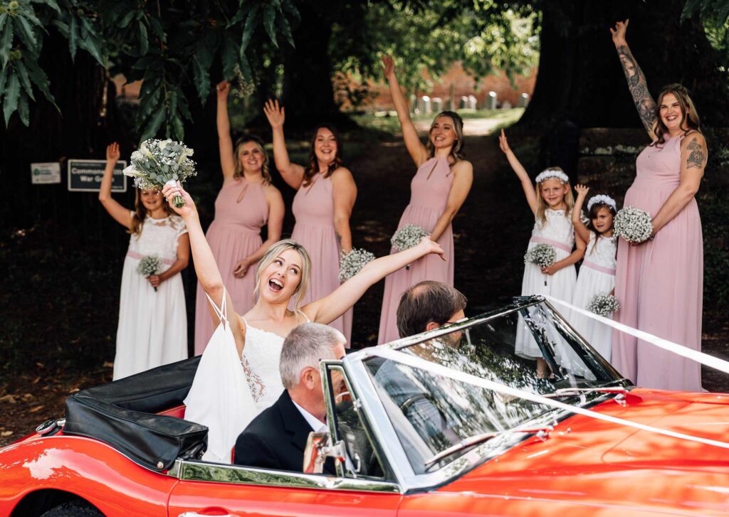 Bride arriving in her roofless wedding car at the church