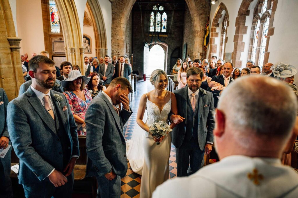 Church wedding ceremony and an emotional groom as his bride arrives