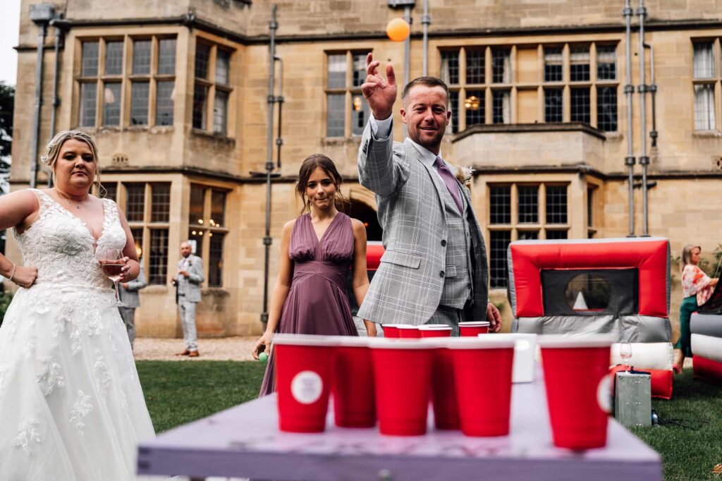 groomsman playing Beer pong game at coombe lodge
