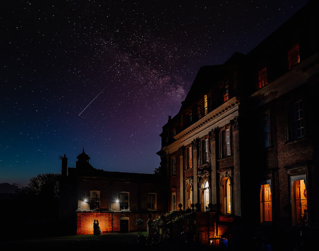 front of Crowcombe court at night all lit up with a clear nights sky