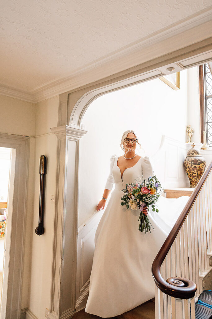 bride walking down the stairs of pennard house