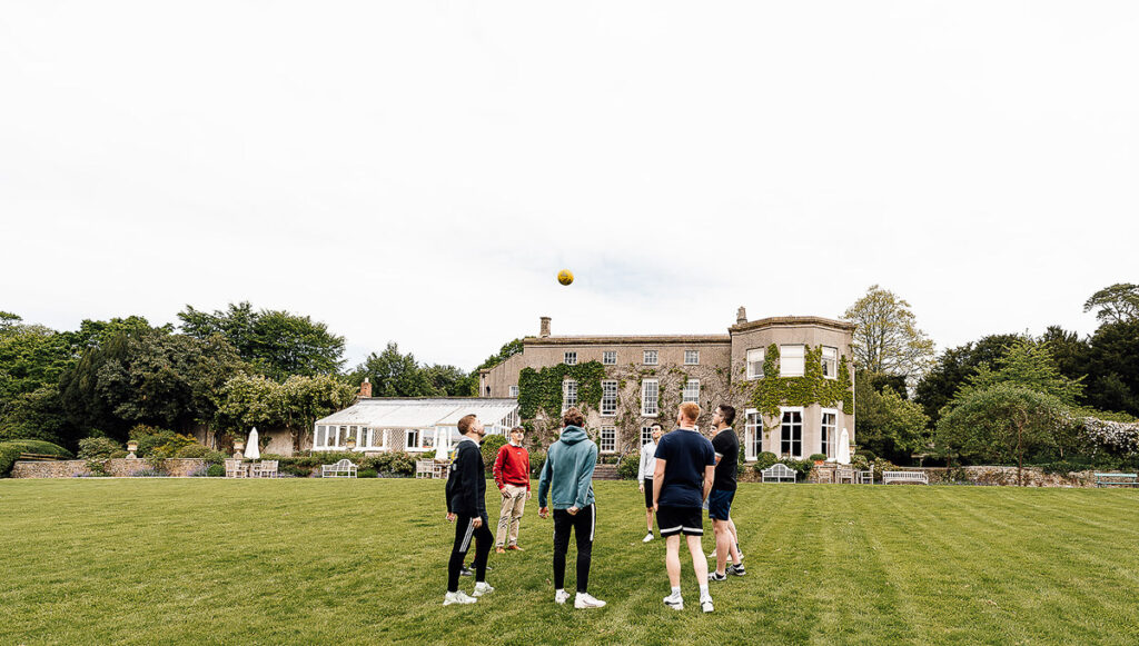 Boys playing football in pennard house garden