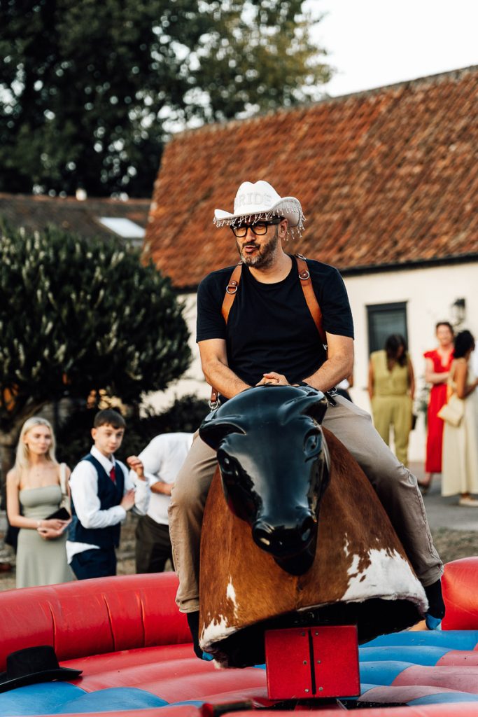Paul Aston Photography Riding a mechanical bull at Aldwick wedding venue